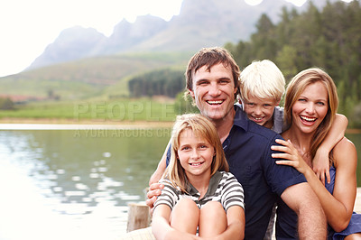 Buy stock photo Portrait, family and laughing in nature, lake and holiday for parents and children, vacation and fun. Water, mom and dad with kids, bonding and travel to river for peace, man and woman with smile