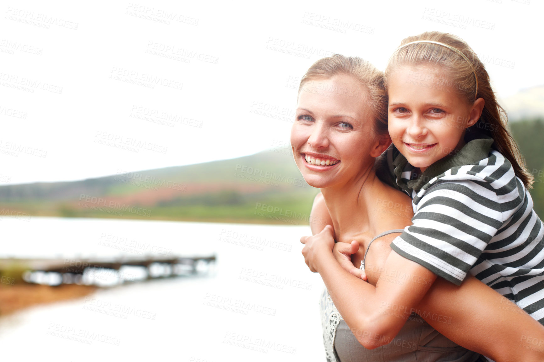 Buy stock photo Mom, girl and piggyback portrait by water, happiness and trust for outdoor adventure in nature. Mother, daughter and carrying support or games by river, love and bonding on holiday for connection