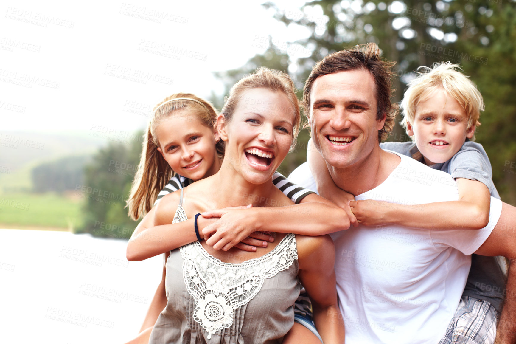 Buy stock photo Family, piggyback and laugh in outdoor portrait, lake holiday and bonding together on weekend trip. Parents, children and carrying kids for support on vacation, love and smile for fun by river water