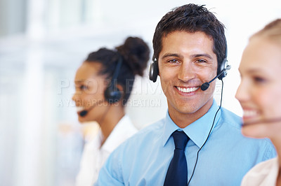 Buy stock photo Man, portrait and smile in call center for customer service, telemarketing and FAQ in office. Male consultant, happy and headset at help desk with team, communication or bilingual agent with tech