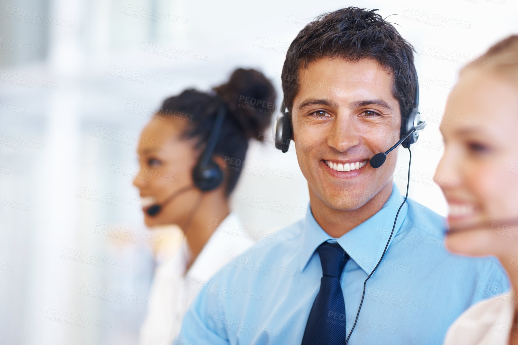 Buy stock photo Man, portrait and smile in call center for customer service, telemarketing and FAQ in office. Male consultant, happy and headset at help desk with team, communication or bilingual agent with tech