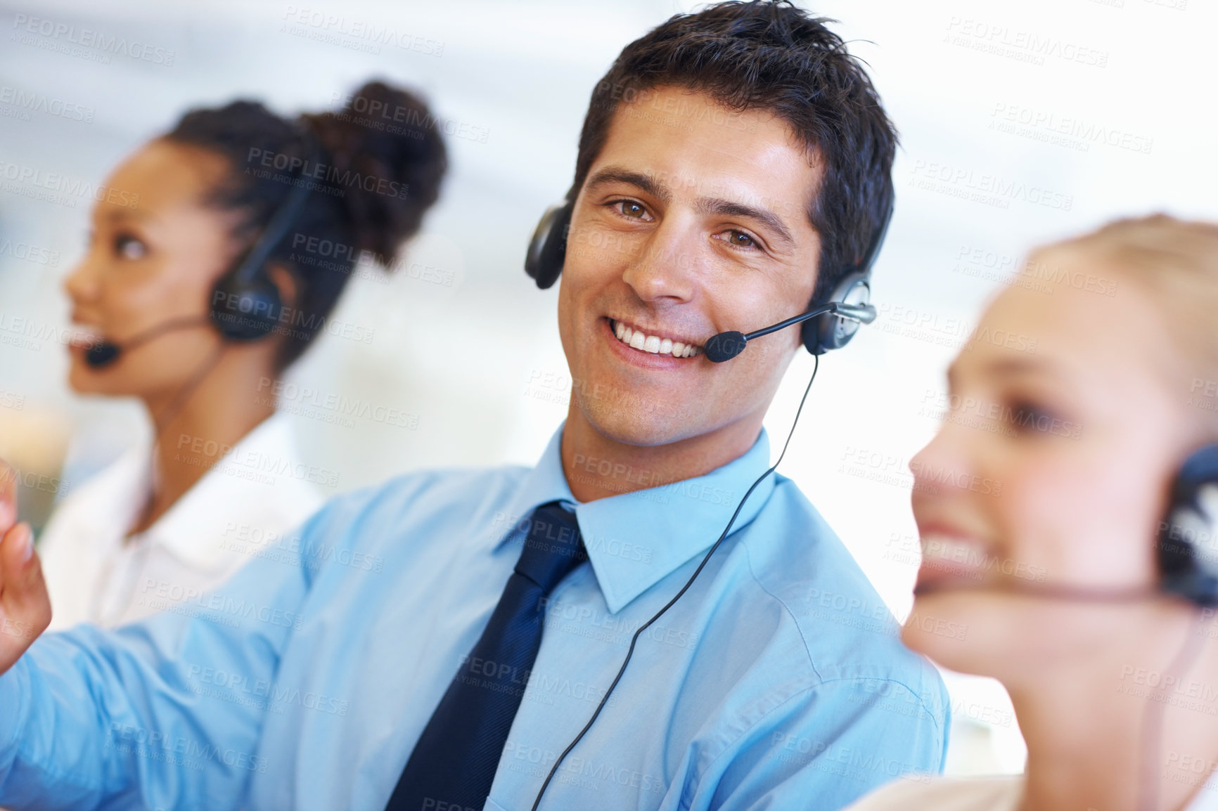 Buy stock photo Portrait of happy male operator with female employees at call center