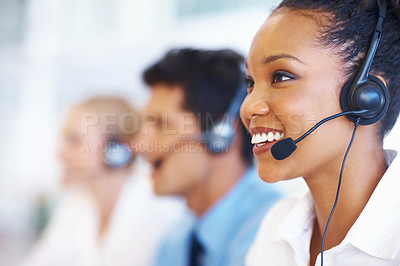 Buy stock photo Closeup of African American operator on call with colleagues in background