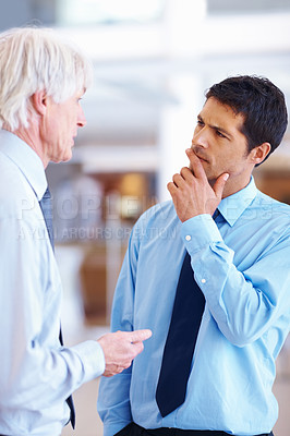 Buy stock photo Portrait of senior executive giving suggestions to junior business man at office