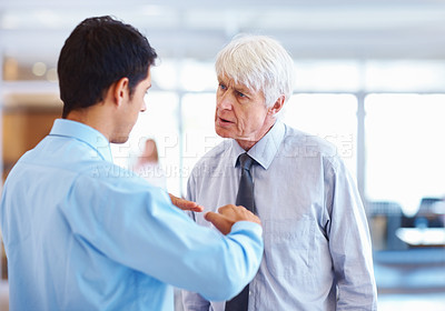 Buy stock photo Portrait of young executive clearing his business doubts with senior business man