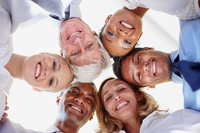 Buy stock photo Low angle view of multi ethnic business group in huddle at office
