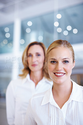 Buy stock photo Portrait of pretty female executive with business woman in background