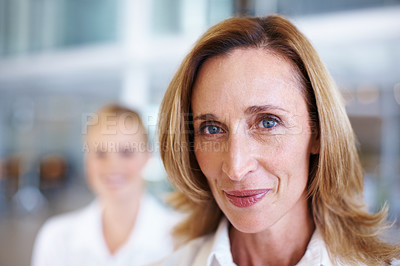 Buy stock photo Closeup of mature business woman with female executive in background