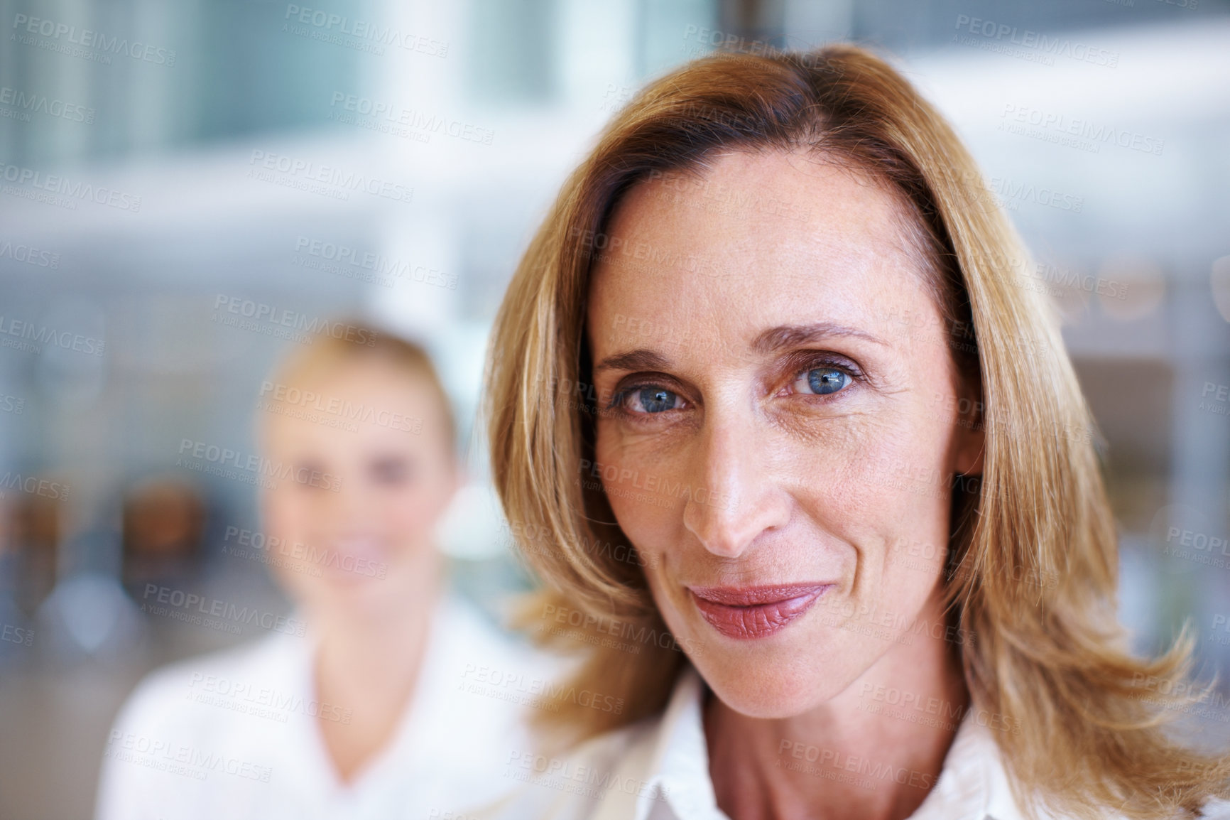 Buy stock photo Closeup of mature business woman with female executive in background