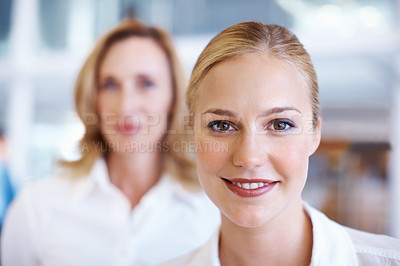 Buy stock photo Closeup of lovely young business woman smiling with female executive in background