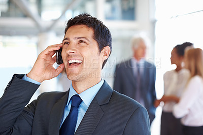 Buy stock photo Portrait of cheerful business man on call with executives conversing in background