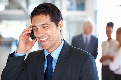 Buy stock photo Portrait of happy young business man on call with executives discussing in background