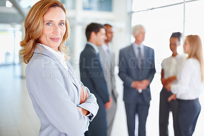 Buy stock photo Portrait of smiling business woman with executives discussing in background