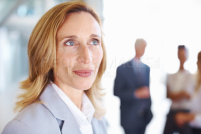 Buy stock photo Closeup of mature business woman contemplating with executives in background