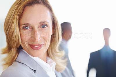 Buy stock photo Closeup of elegant mature business woman smiling with associates in background