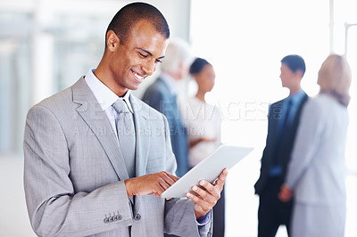 Buy stock photo Portrait of African American business man using digital tablet with executives in background