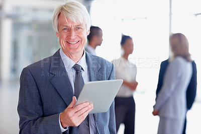 Buy stock photo Portrait of handsome senior business man smiling while using digital tablet with executives