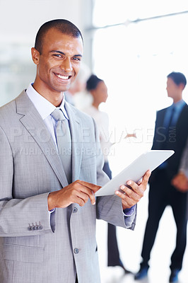 Buy stock photo Portrait of African American male executive using digital tablet with executives in background