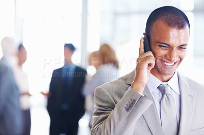 Buy stock photo Portrait of happy African American business man on call with associates in background