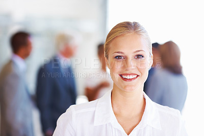 Buy stock photo Portrait of young business woman smiling with team in background