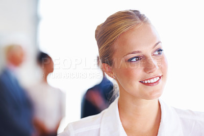Buy stock photo Closeup of beautiful business woman looking away with executives discussing in background