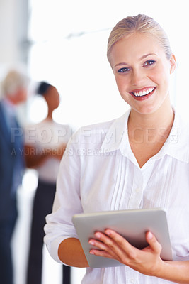 Buy stock photo Portrait of happy young business woman using tablet pc with executives in background