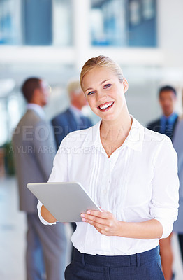 Buy stock photo Portrait of successful business woman using electronic tablet with executives in background