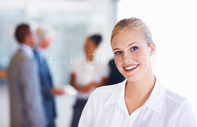 Buy stock photo Portrait of elegant young business woman smiling with associates in background