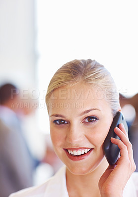 Buy stock photo Closeup of cute young female executive on call with executives in background
