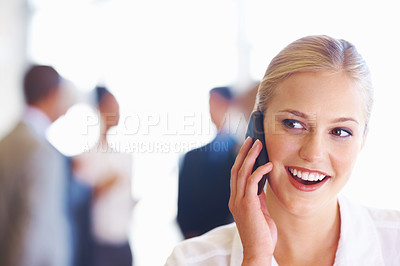 Buy stock photo Closeup of cute female executive on phone call with business team in background