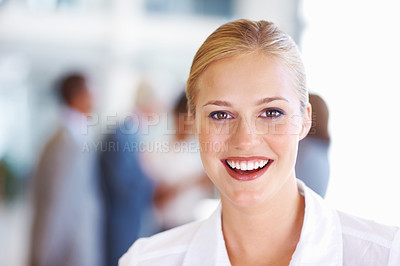 Buy stock photo Closeup of cheerful young business woman with executives in background