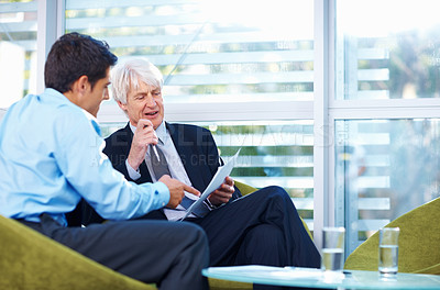 Buy stock photo Portrait of successful male executives having talk about document at office