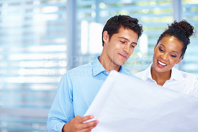 Buy stock photo Portrait of male and female architects working on blueprints