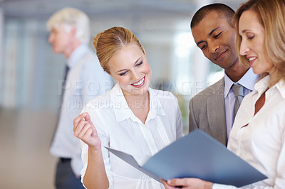 Buy stock photo Portrait of happy multi ethnic executives discussing while looking at documents