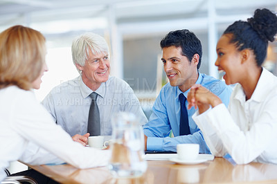 Buy stock photo Portrait of senior male leader with his colleagues discussing at conference room