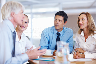 Buy stock photo Portrait of business people listening to their senior leader in meeting