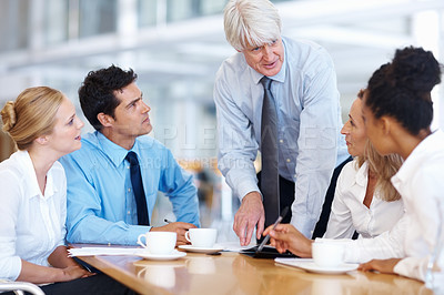 Buy stock photo Portrait of successful business team listening to their senior leader at office
