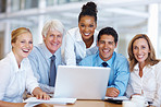Smiling business people using laptop