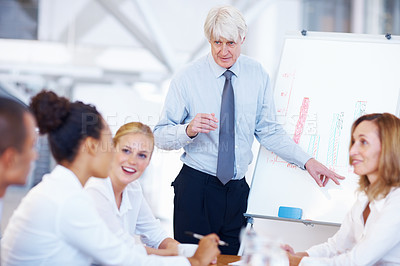 Buy stock photo Portrait of successful senior business man presenting to his colleagues