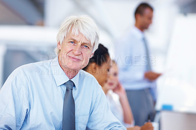 Buy stock photo Portrait of confident senior business man smiling with executives in background