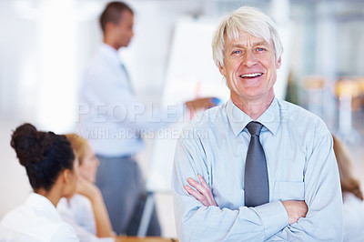 Buy stock photo Portrait of elegant senior business man smiling with executives in background