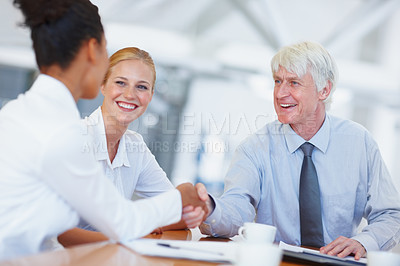 Buy stock photo Portrait of senior business man shaking hands with female executive at office