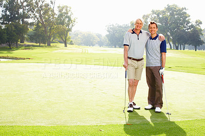 Buy stock photo Full length of father and son standing on golf course with arms around