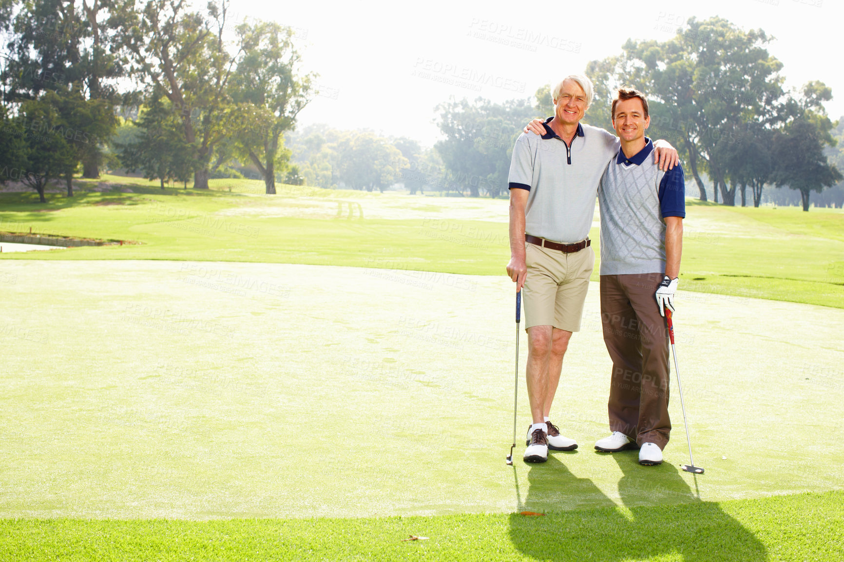 Buy stock photo Portrait, golf course and father with son, hug and grass field with fitness, recreation and health. Face, family or people with smile, embrace or happiness with training, routine or hobby with sports