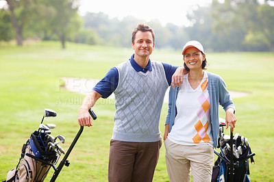 Buy stock photo Portrait of couple standing on grass with golf kit and smiling