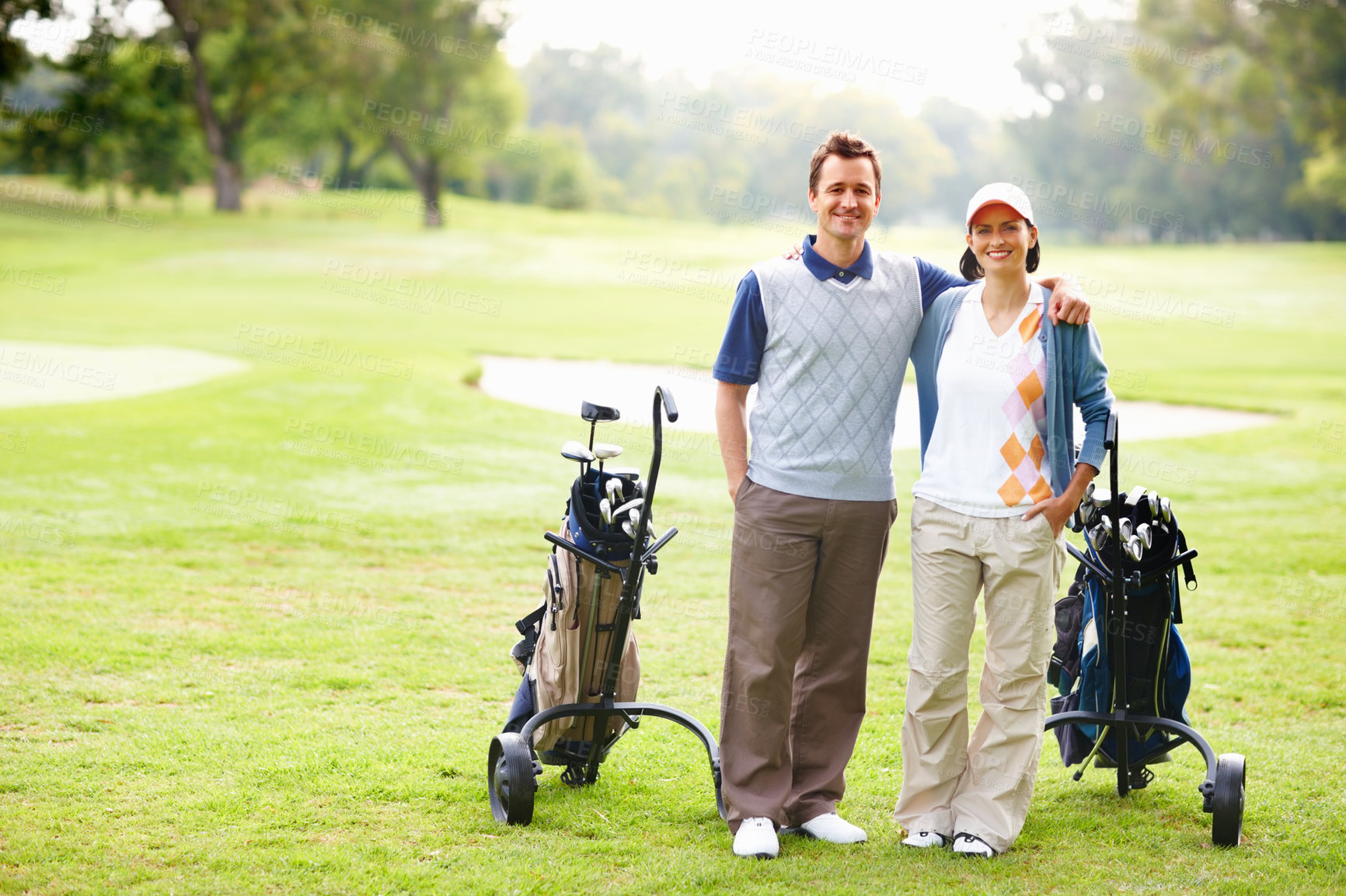 Buy stock photo Smile, portrait and couple on golf course for game, outdoor fun and fitness on weekend morning. Love, happy woman and man on green grass for romantic sports date, health and wellness with exercise.