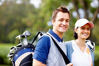 Buy stock photo Portrait of couple giving you a cute smile with man holding a golf bag