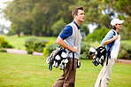 Couple walking with golf bags