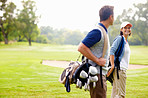 Female golfer smiling and looking at man