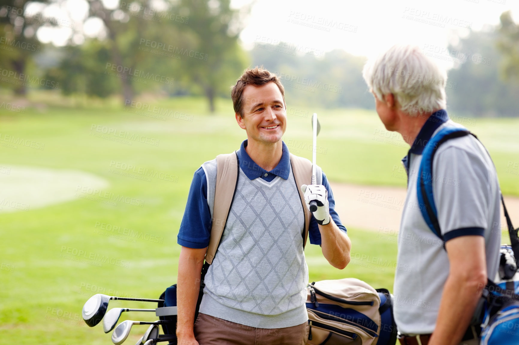 Buy stock photo Father, son and happy on course for golf, sports and bonding outdoor with equipment bag or conversation. Elderly person, man and smile on grass for hobby, talking and playing game at country club